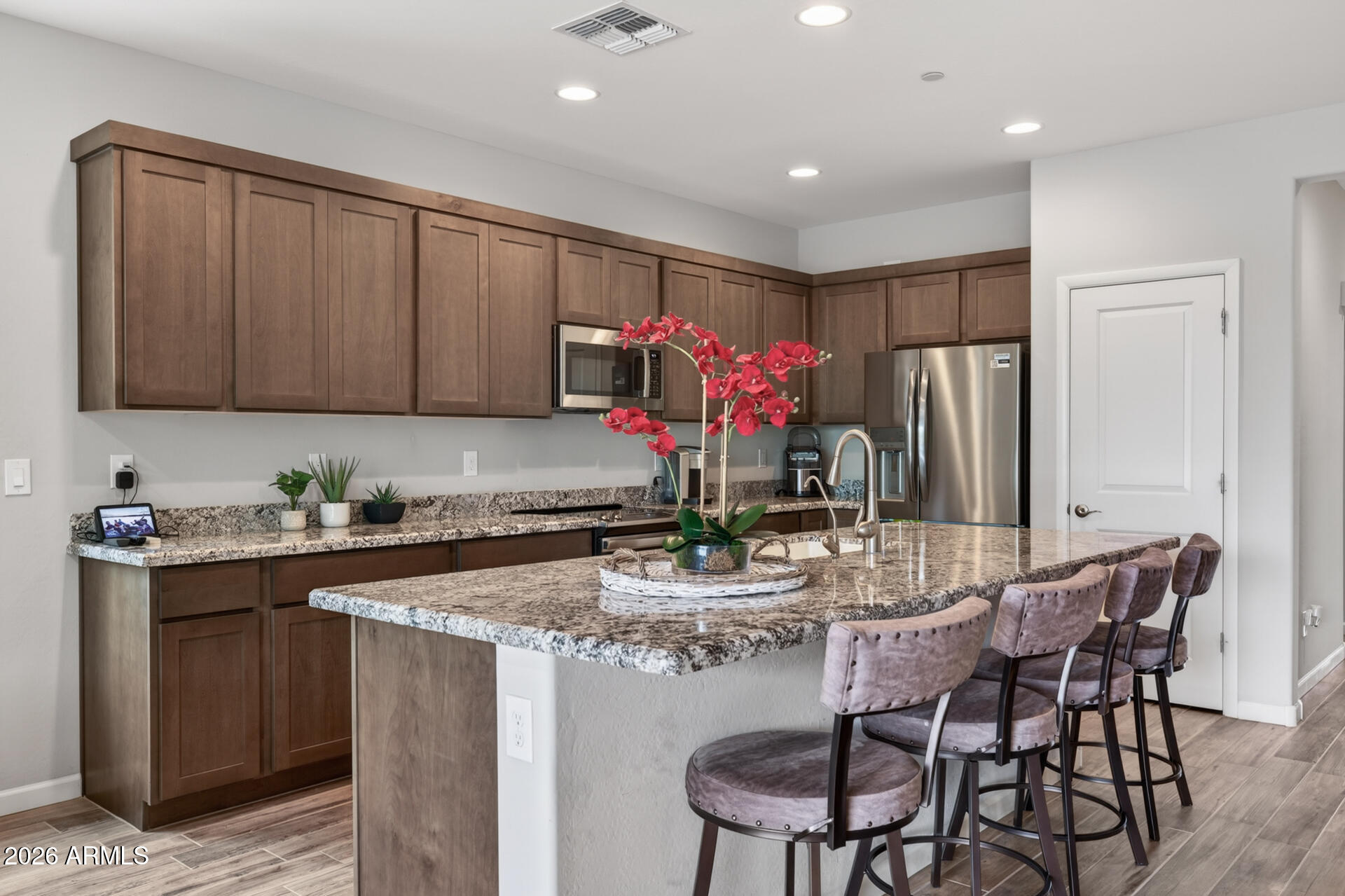 17443 East Cindercone Road Rio Verde, AZ 85263 - Photo 11 of 70 a kitchen with kitchen island granite countertop a table and chairs in it