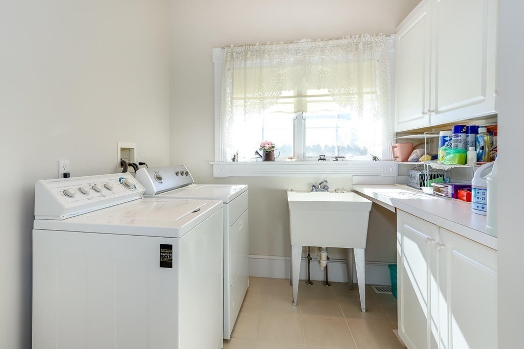 12 Cherokee Road Canton, MA 02021 - Photo 21 of 39 a utility room with cabinets dryer and washer