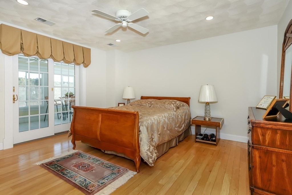 12 Cherokee Road Canton, MA 02021 - Photo 27 of 39 a spacious bedroom with a bed and wooden floor