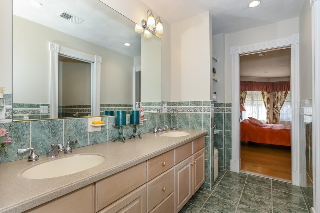12 Cherokee Road Canton, MA 02021 - Photo 31 of 39 a bathroom with a double vanity sink and a mirror