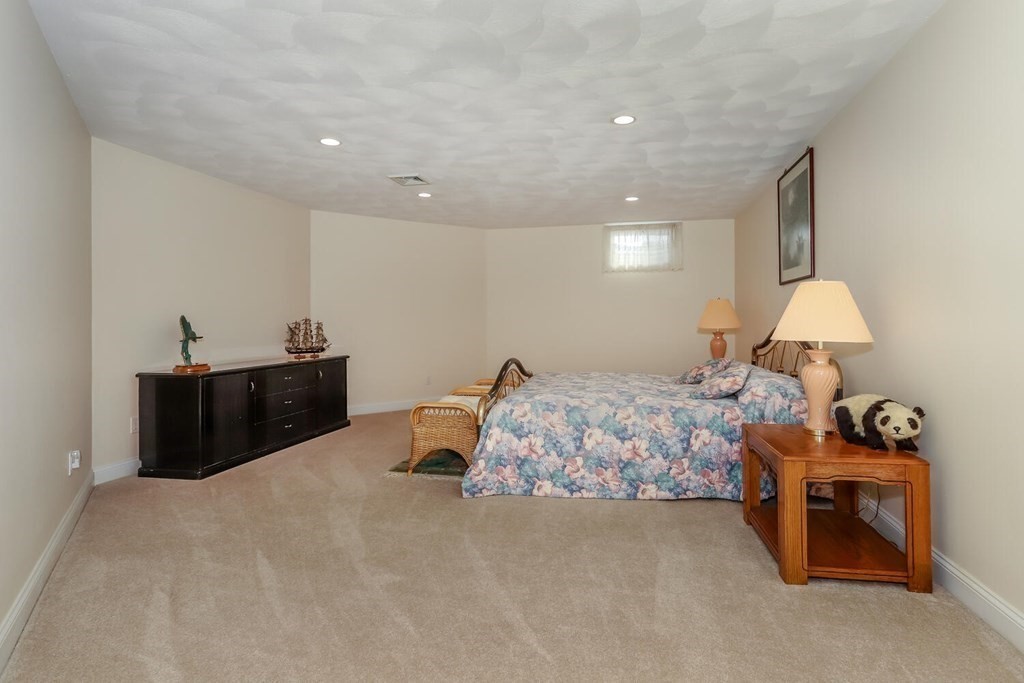 12 Cherokee Road Canton, MA 02021 - Photo 34 of 39 a spacious bedroom with a bed and a lamp