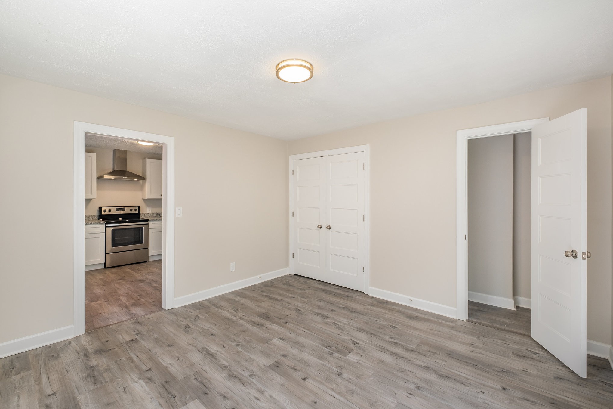 417 West Coffee Street Tullahoma, TN 37388 - Photo 15 of 34 a view of kitchen and empty room with wooden floor