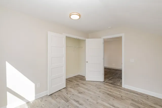 an empty room with wooden floor