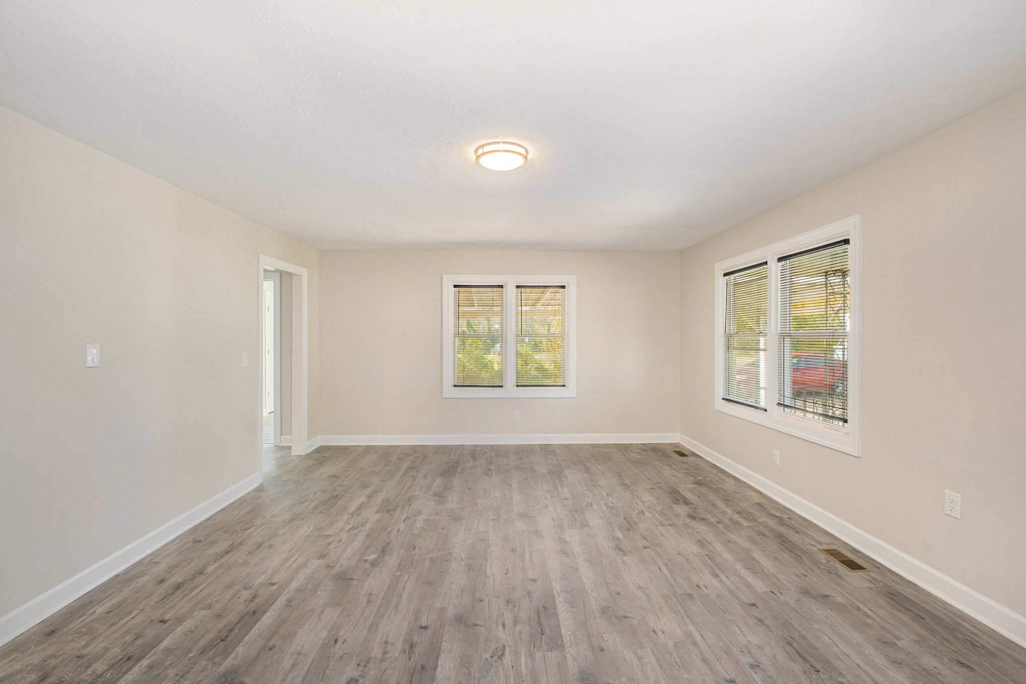 417 West Coffee Street Tullahoma, TN 37388 - Photo 20 of 34 an empty room with wooden floor and windows
