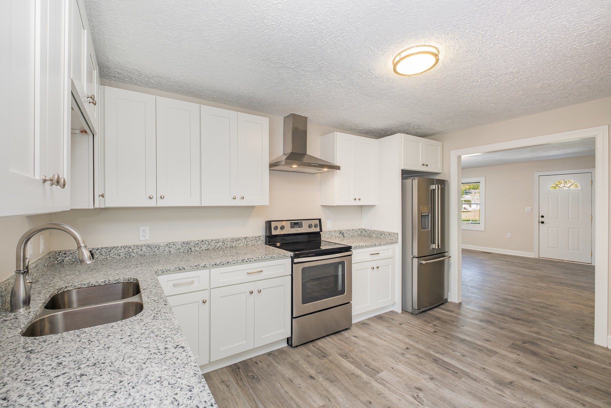417 West Coffee Street Tullahoma, TN 37388 - Photo 6 of 34 a kitchen with stainless steel appliances granite countertop a sink stove and refrigerator