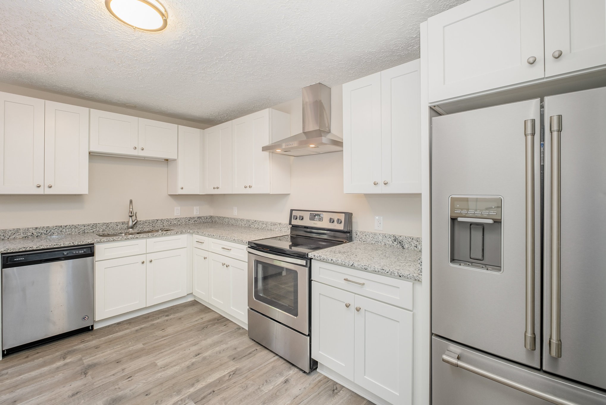 417 West Coffee Street Tullahoma, TN 37388 - Photo 7 of 34 a kitchen with stainless steel appliances granite countertop a sink stove and refrigerator