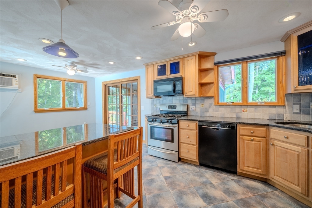 24 Governor Peabody Road Billerica, MA 01821 - Photo 4 of 42 a kitchen with stainless steel appliances granite countertop a stove and a sink