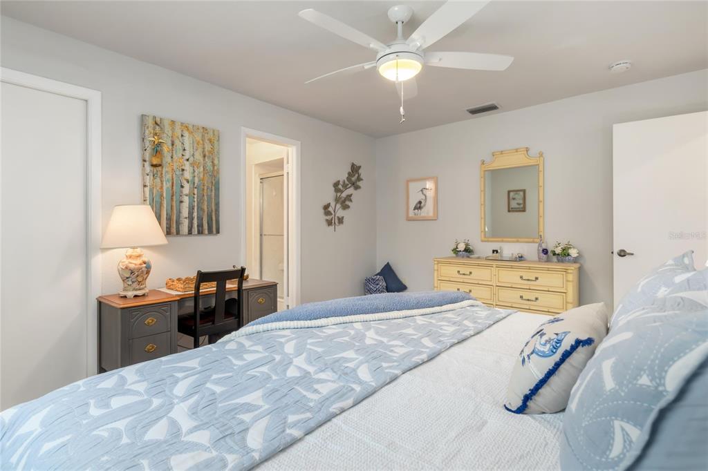 774 Spring Lake Boulevard Northwest Port Charlotte, FL 33952 - Photo 14 of 29 a bedroom with a bed and wooden floor