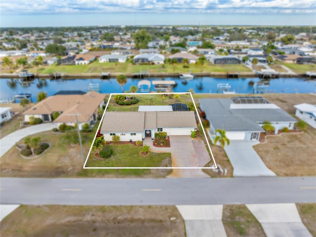 774 Spring Lake Boulevard Northwest Port Charlotte, FL 33952 - Photo 23 of 29 an aerial view of a house with a swimming pool