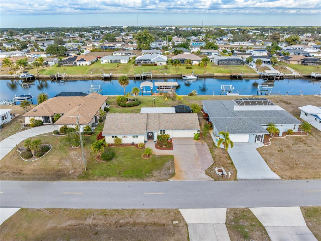 774 Spring Lake Boulevard Northwest Port Charlotte, FL 33952 - Photo 24 of 29 an aerial view of residential houses with outdoor space