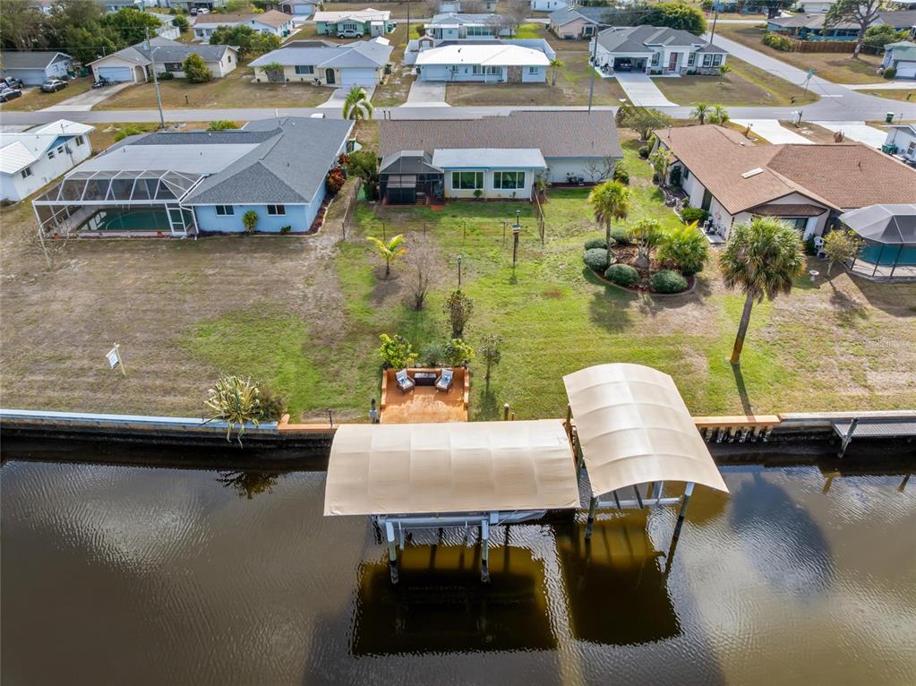 774 Spring Lake Boulevard Northwest Port Charlotte, FL 33952 - Photo 28 of 29 an aerial view of a house with swimming pool and outdoor seating