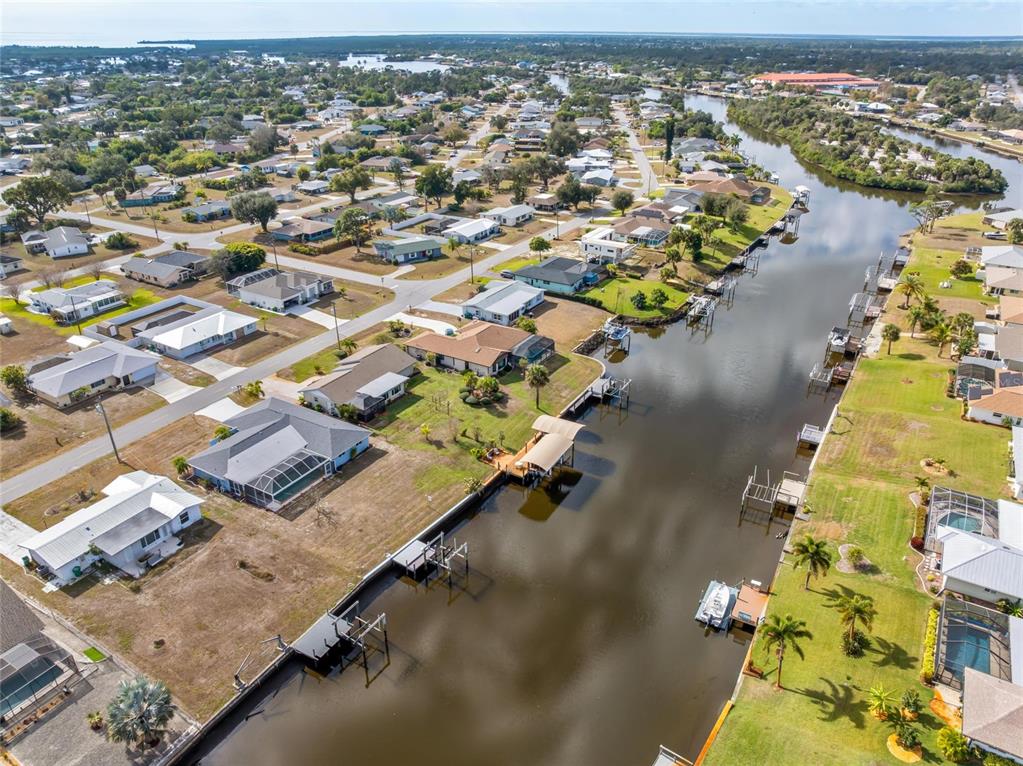 774 Spring Lake Boulevard Northwest Port Charlotte, FL 33952 - Photo 29 of 29 an aerial view of residential houses with outdoor space