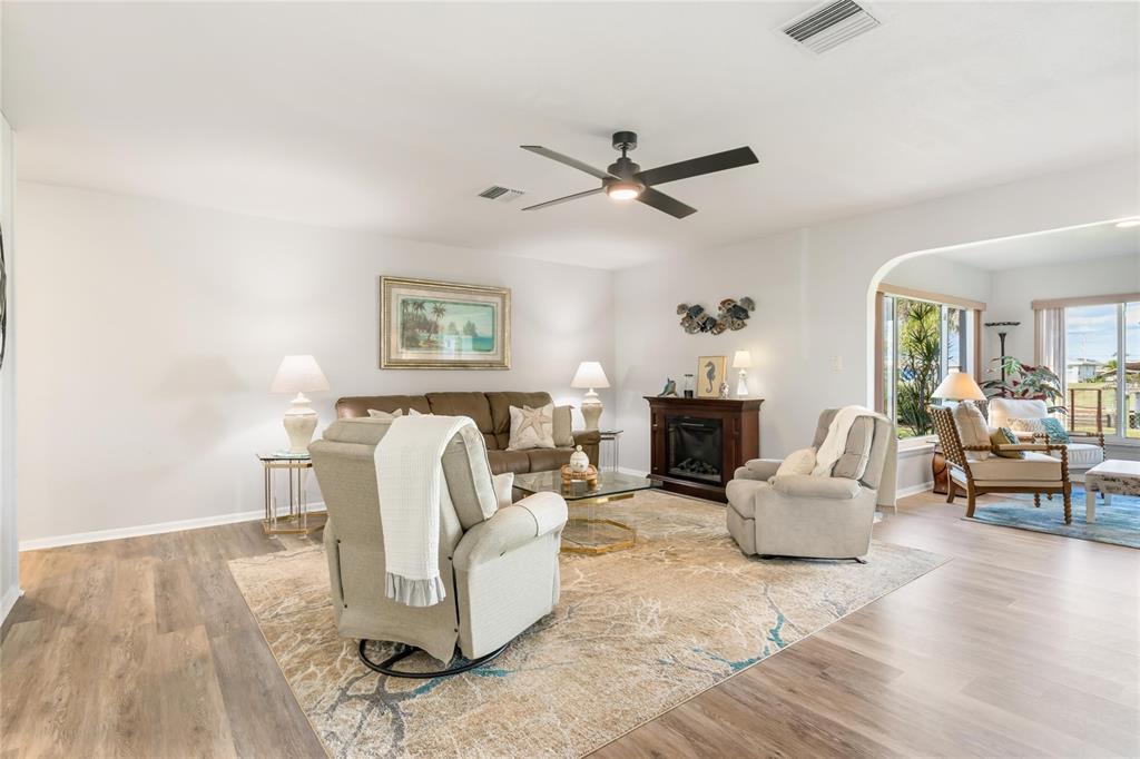 774 Spring Lake Boulevard Northwest Port Charlotte, FL 33952 - Photo 4 of 29 a living room with furniture and a fireplace