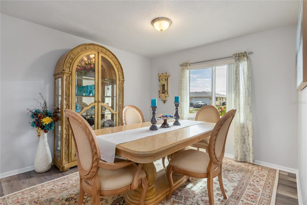 774 Spring Lake Boulevard Northwest Port Charlotte, FL 33952 - Photo 7 of 29 a view of a dining room with furniture and a window