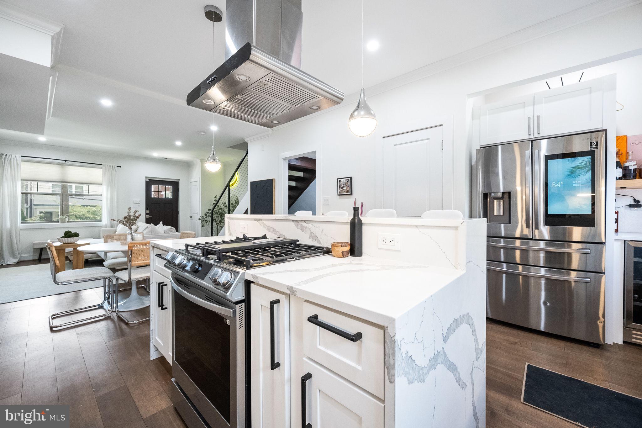 4625 4th Street Northwest Washington, DC 20011 - Photo 13 of 41 a kitchen with stainless steel appliances granite countertop a stove and a refrigerator