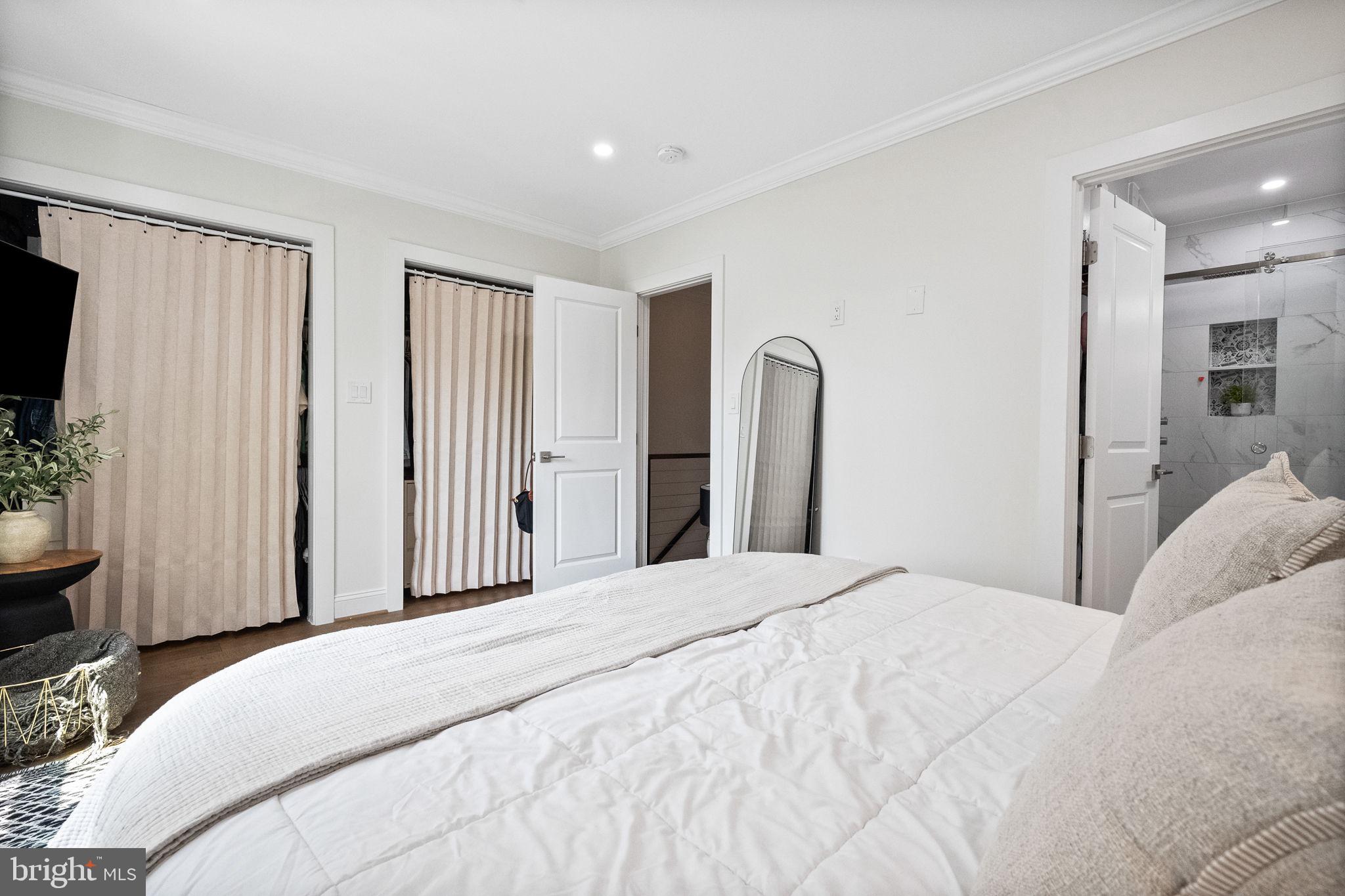 4625 4th Street Northwest Washington, DC 20011 - Photo 20 of 41 a bedroom with a large bed and a flat screen tv