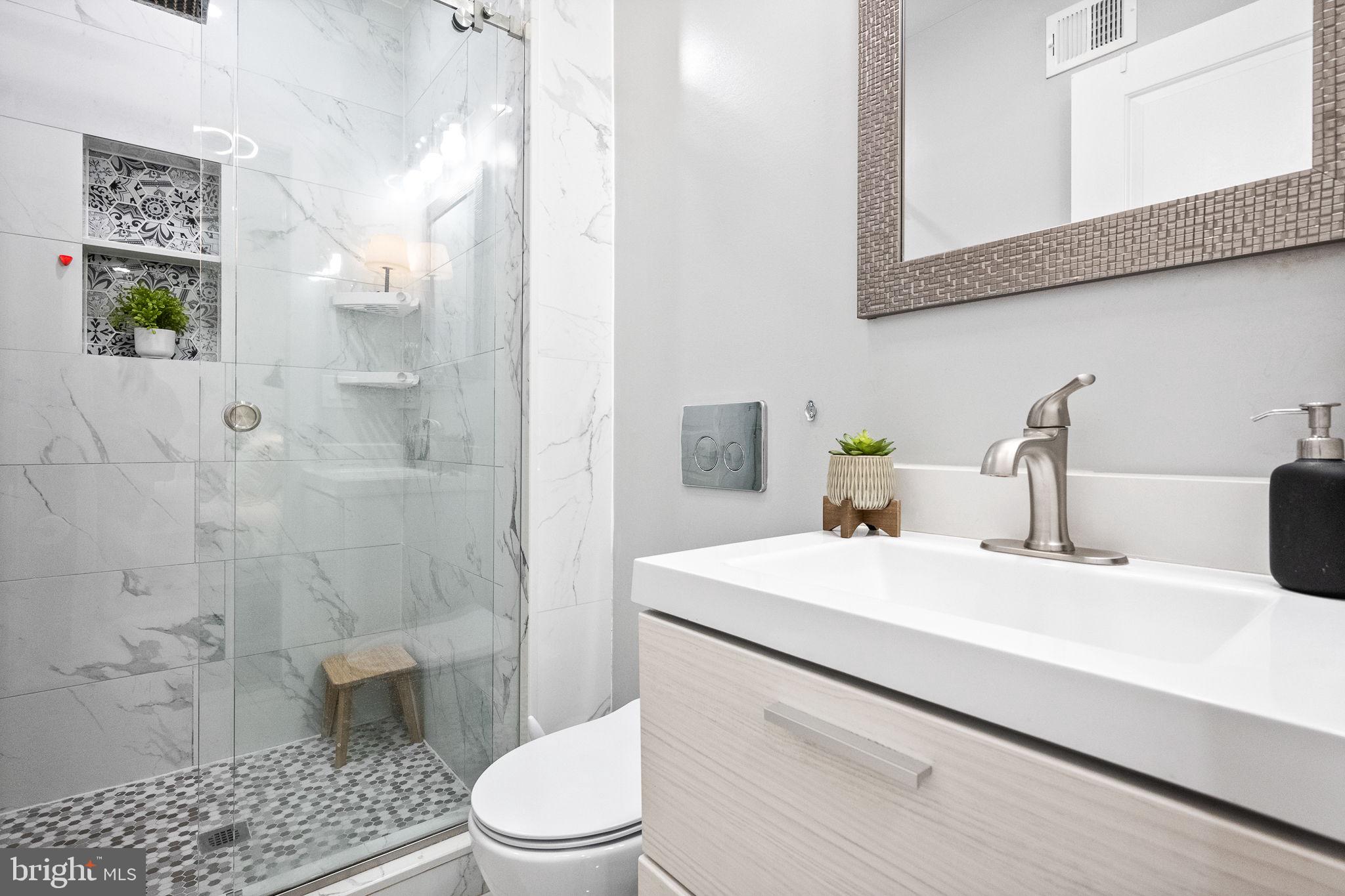 4625 4th Street Northwest Washington, DC 20011 - Photo 21 of 41 a bathroom with a sink a toilet and shower