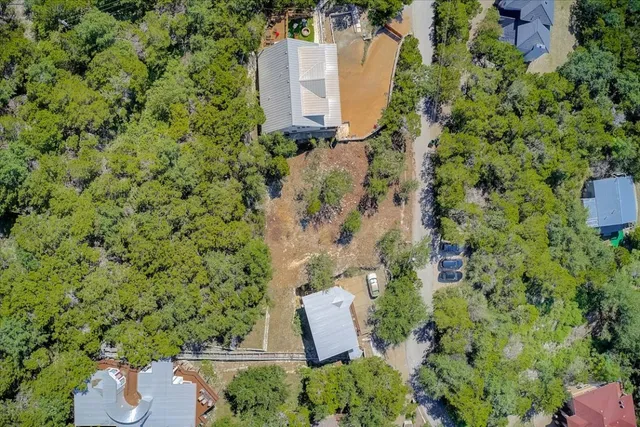 an aerial view of a house with a yard