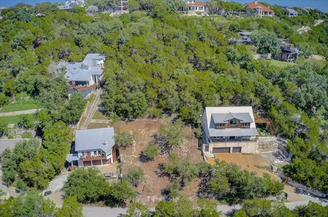 an aerial view of a house with a yard