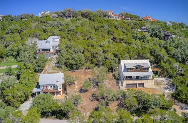 an aerial view of a house with a yard