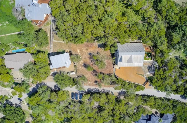 an aerial view of a house with a yard and trees