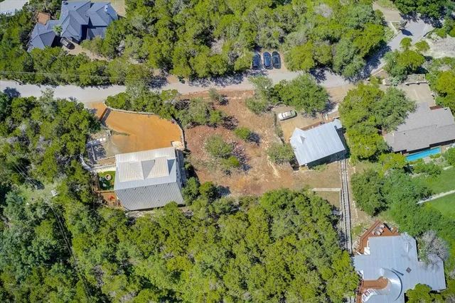 an aerial view of a house with a yard and lake view
