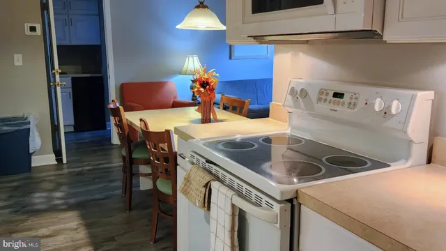 a kitchen with stainless steel appliances kitchen island a refrigerator sink and cabinets