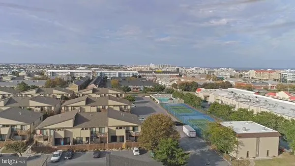 an aerial view of residential houses with city view