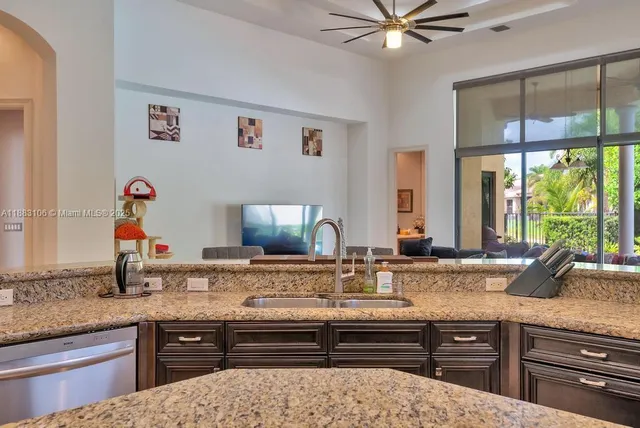 a view of a dining room with furniture a chandelier and wooden floor