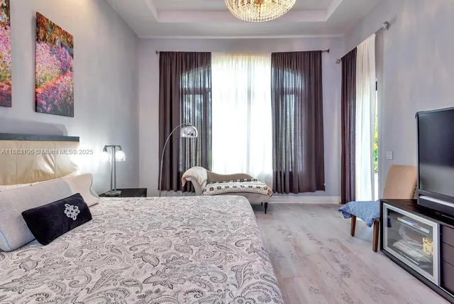 a bedroom with a bed and a flat screen tv