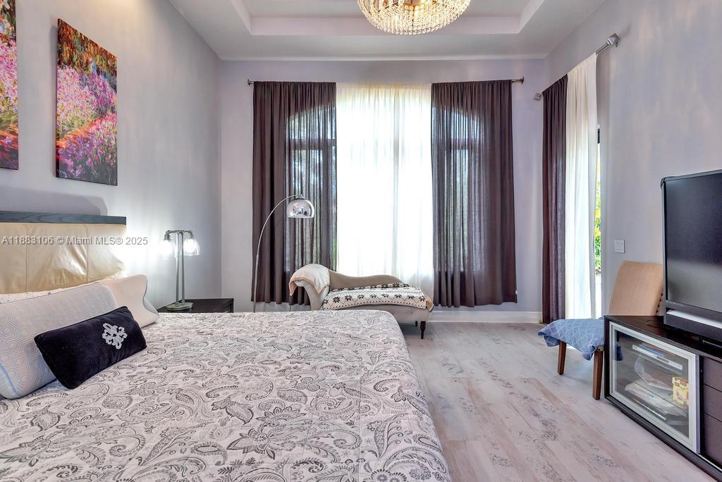 17931 Lake Azure Way Boca Raton, FL 33496 - Photo 23 of 59 a bedroom with a bed and a television