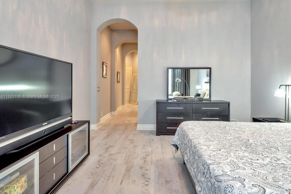 17931 Lake Azure Way Boca Raton, FL 33496 - Photo 25 of 59 a bedroom with a bed and a flat screen tv