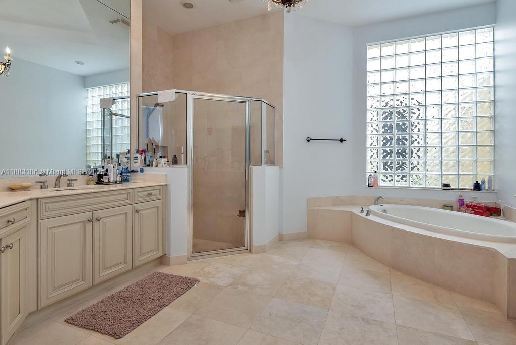 17931 Lake Azure Way Boca Raton, FL 33496 - Photo 27 of 59 a spacious bathroom with a tub sink and mirror