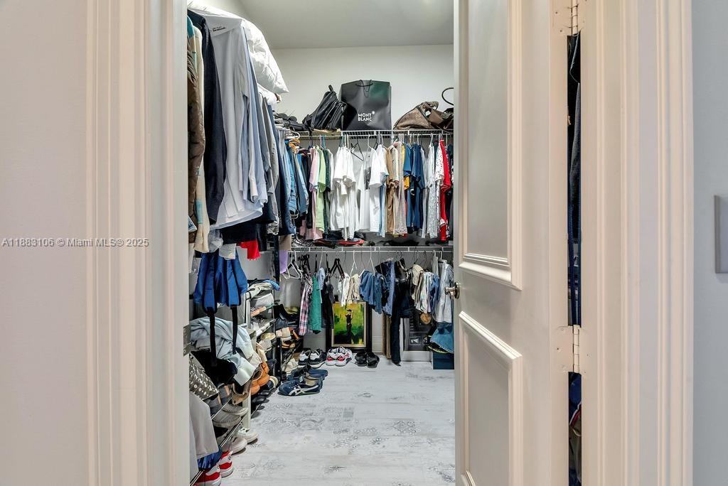17931 Lake Azure Way Boca Raton, FL 33496 - Photo 29 of 59 a view of walk in closet with clothes