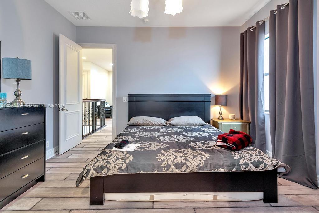 17931 Lake Azure Way Boca Raton, FL 33496 - Photo 33 of 59 a bedroom with a bed and a window