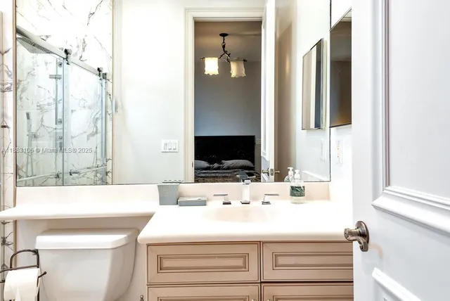 a bedroom with a large bed and a chandelier