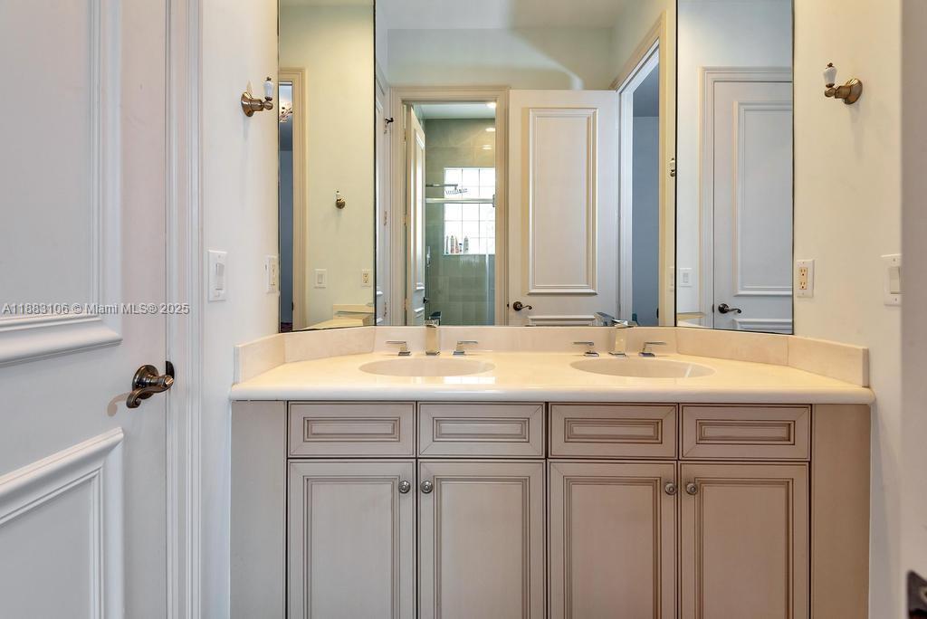 17931 Lake Azure Way Boca Raton, FL 33496 - Photo 37 of 59 a bathroom with a double vanity sink and a mirror