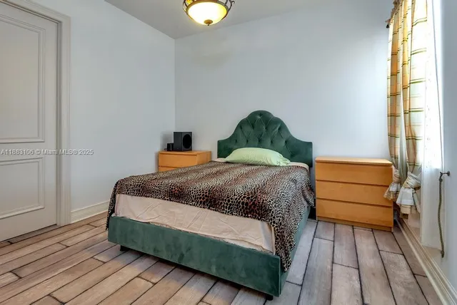 a bedroom with a bed and a mirror