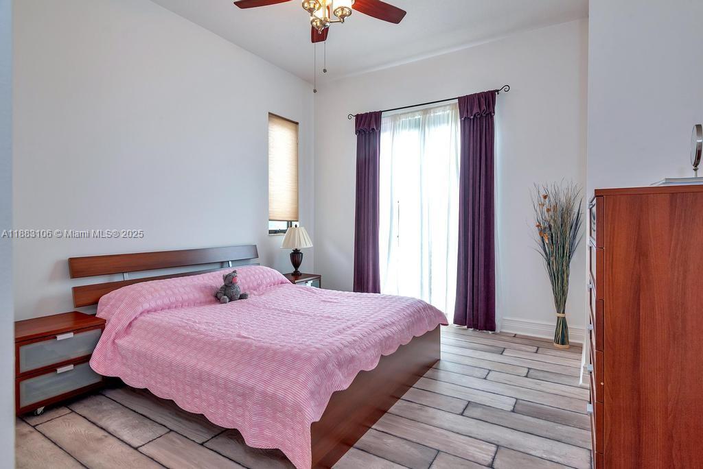 17931 Lake Azure Way Boca Raton, FL 33496 - Photo 46 of 59 a bedroom with a bed dresser and a window