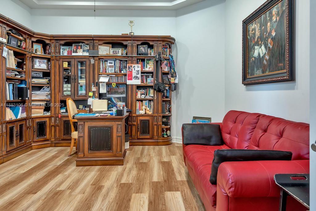 17931 Lake Azure Way Boca Raton, FL 33496 - Photo 48 of 59 a living room with furniture a book shelf and a bookshelf