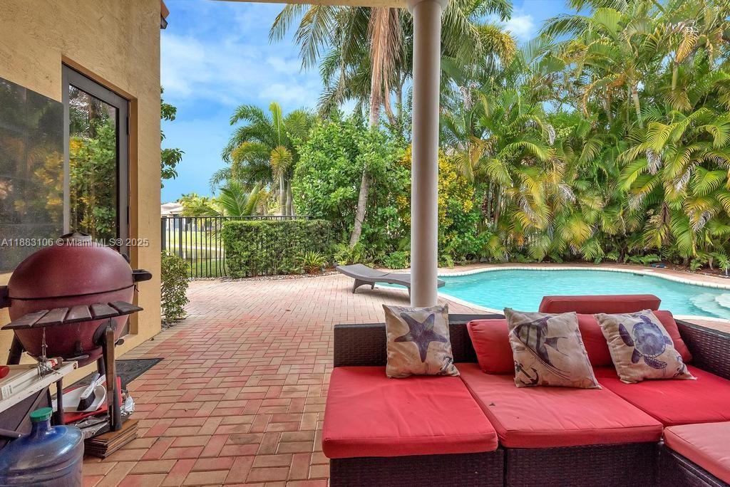 17931 Lake Azure Way Boca Raton, FL 33496 - Photo 57 of 59 a backyard of a house with barbeque oven table and chairs