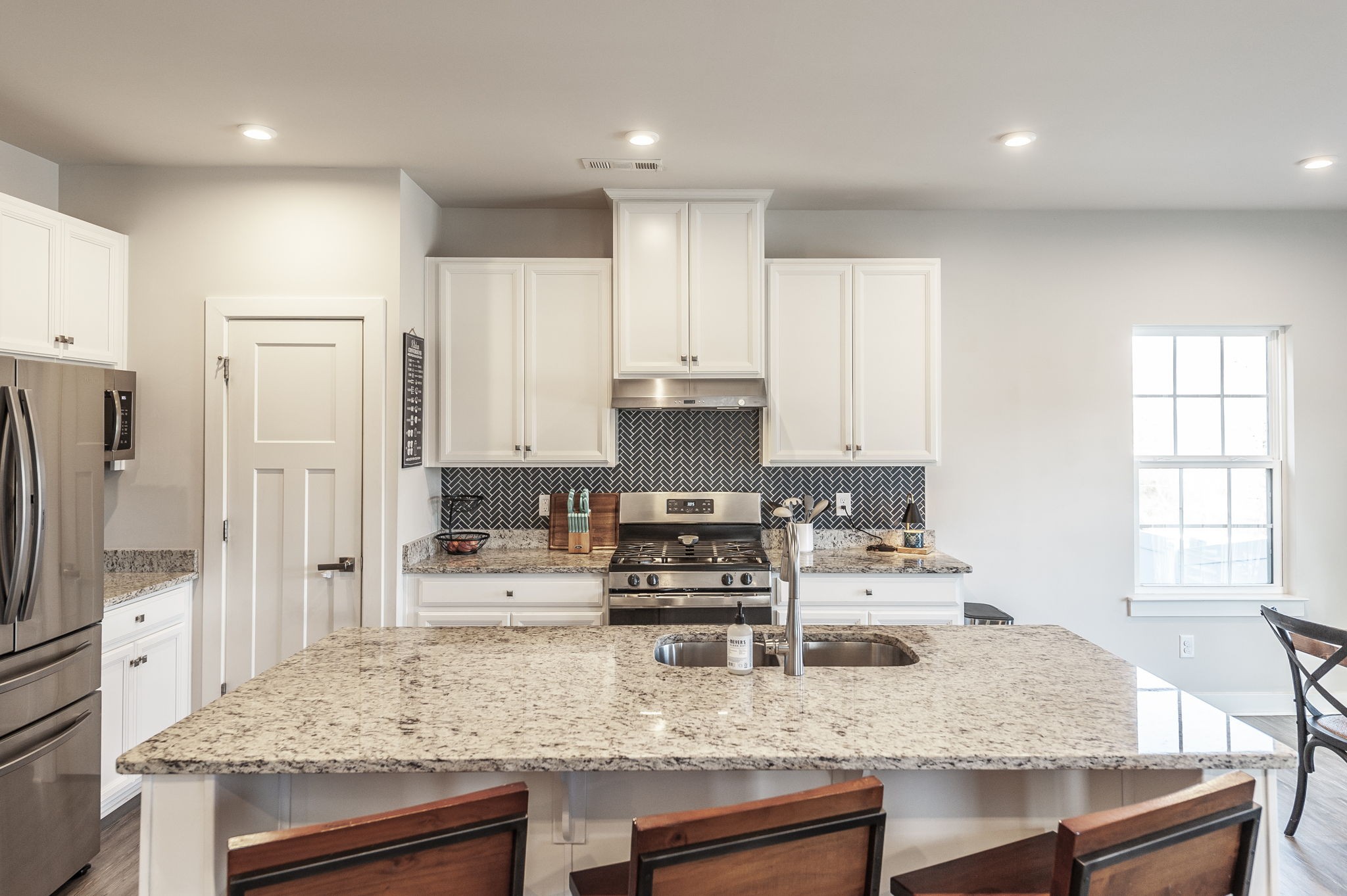 86 French Street Goodlettsville, TN 37072 - Photo 3 of 32 a kitchen with kitchen island granite countertop a stove refrigerator and cabinets