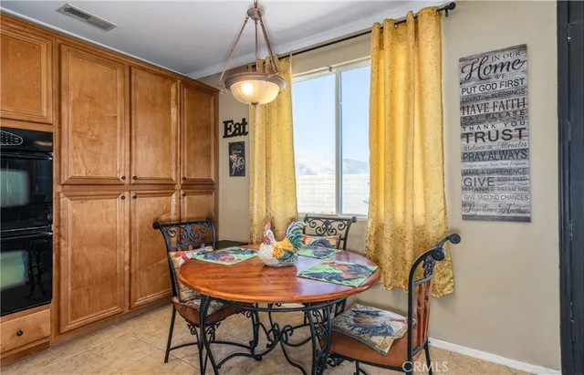 a view of a dining room with furniture and window