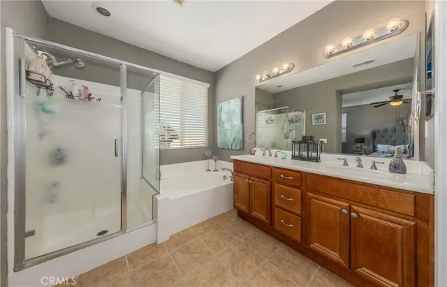 a spacious bathroom with a tub sink shower and mirror