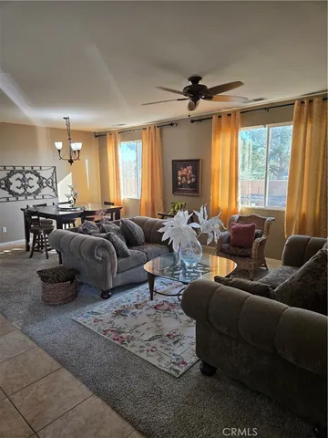 a living room with furniture large window and flat screen tv
