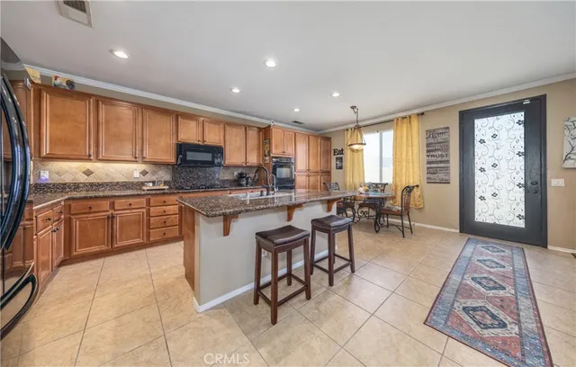 a kitchen with a sink window and cabinets