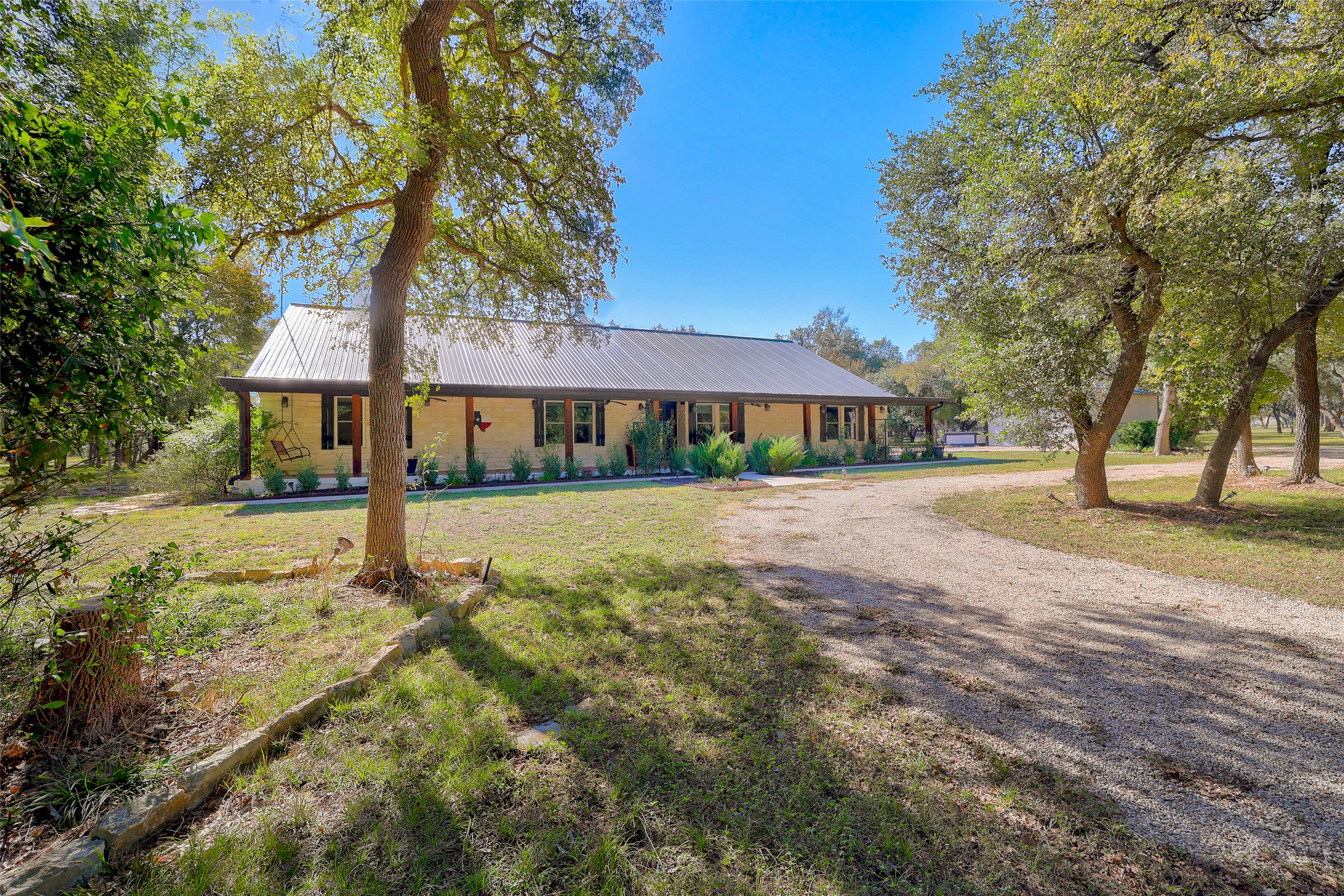 30309 Live Oak Trail Georgetown, TX 78633 - Photo 13 of 40 Beautiful farmhouse style with black metal roof, and extended front porch.