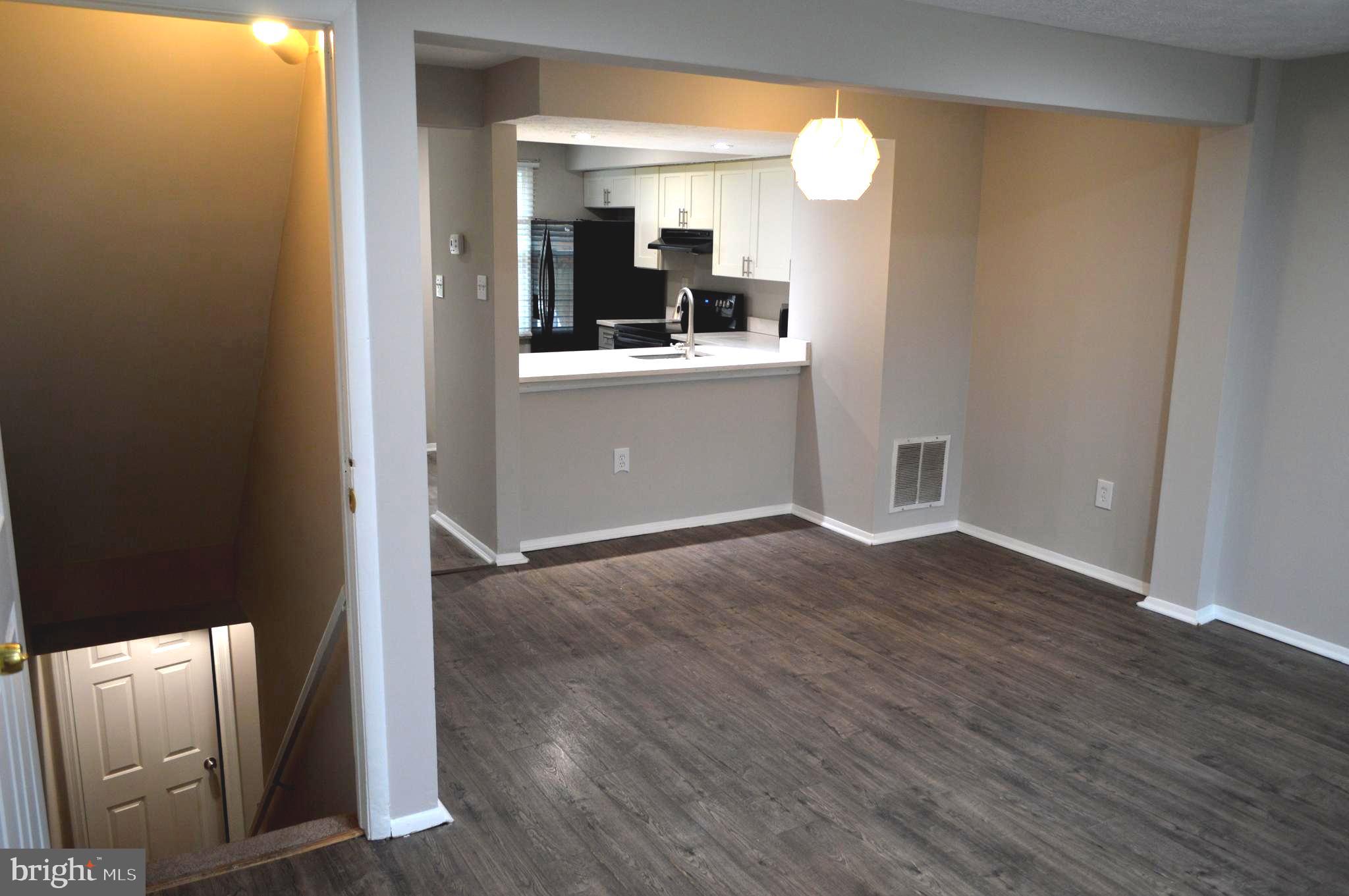 13965 Palmer House Way, Unit 27195 Silver Spring, MD 20904 - Photo 12 of 16 a view of a kitchen cabinets and a wooden floor