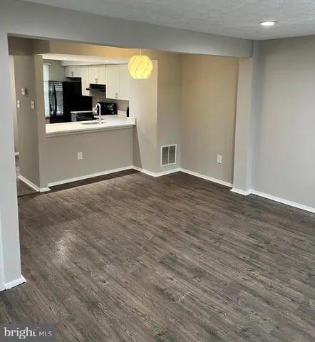 a view of a kitchen with a sink and cabinets