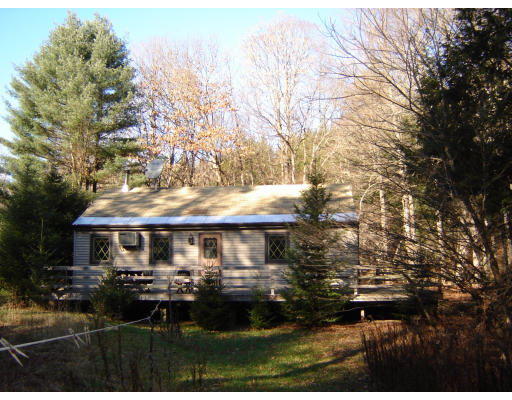 30 East River Road Chester, MA 01011 - Photo 1 of 1 a front view of house with yard and trees around